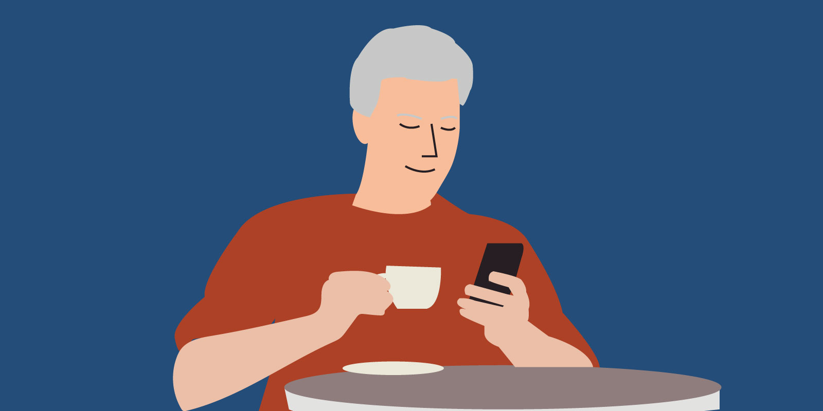 A man sat at a table drinking a coffee and accessing Sleepstation on his mobile phone.