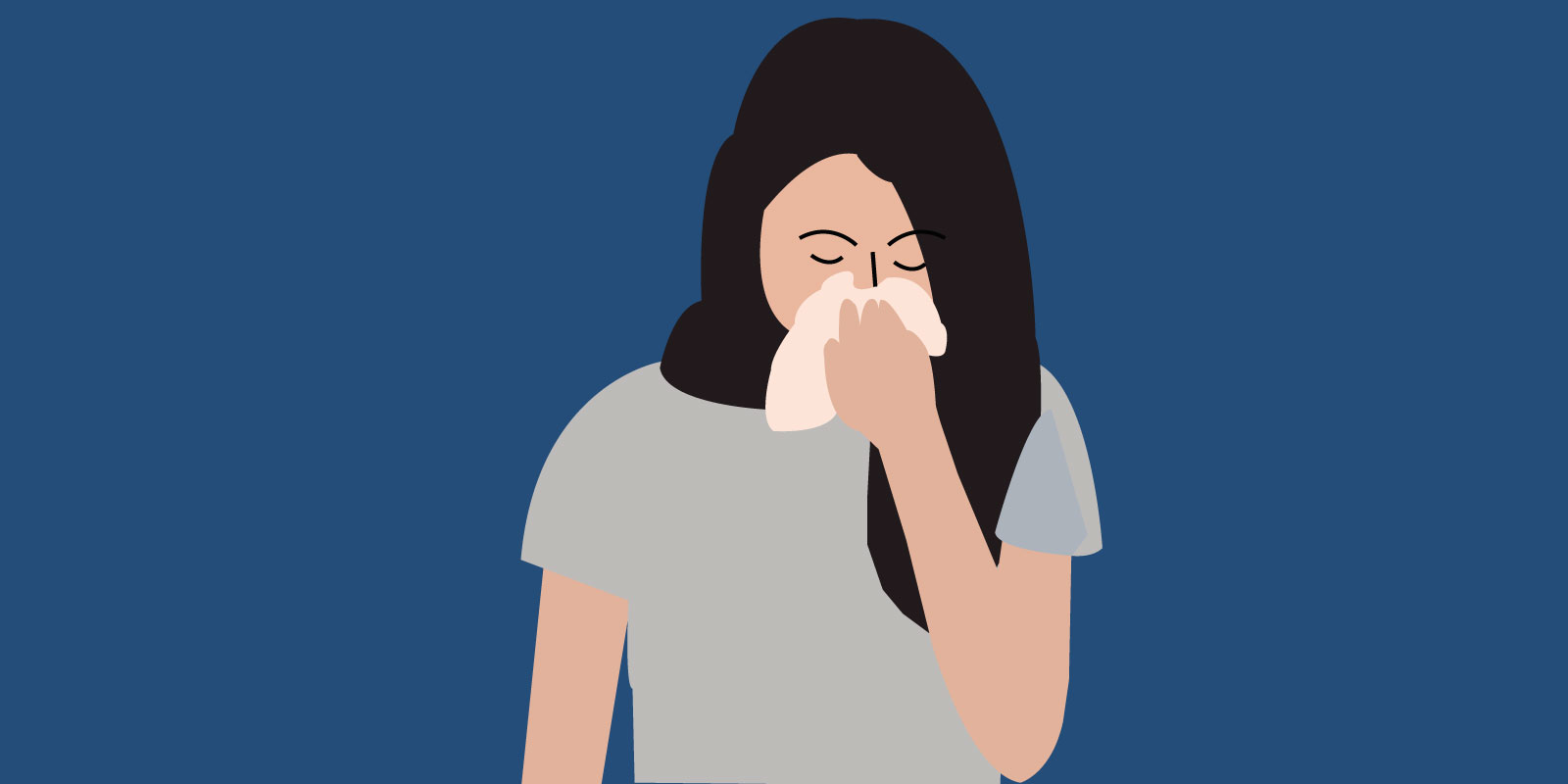 Hydroxyzine: A woman sneezing into a tissue.